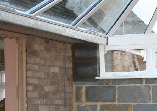 Building Control told AB Conservatories to immediately build this brick pillar as structural integrity of the box gutter could not be assured.  See a review of AB Conservatories Ltd here.